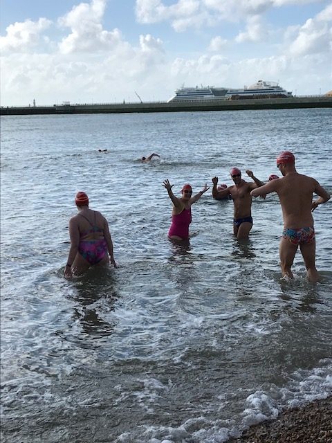 Queen of Hideous Swims #3 Vicki stands in the sea at Dover with 3 friends, posing for the camera